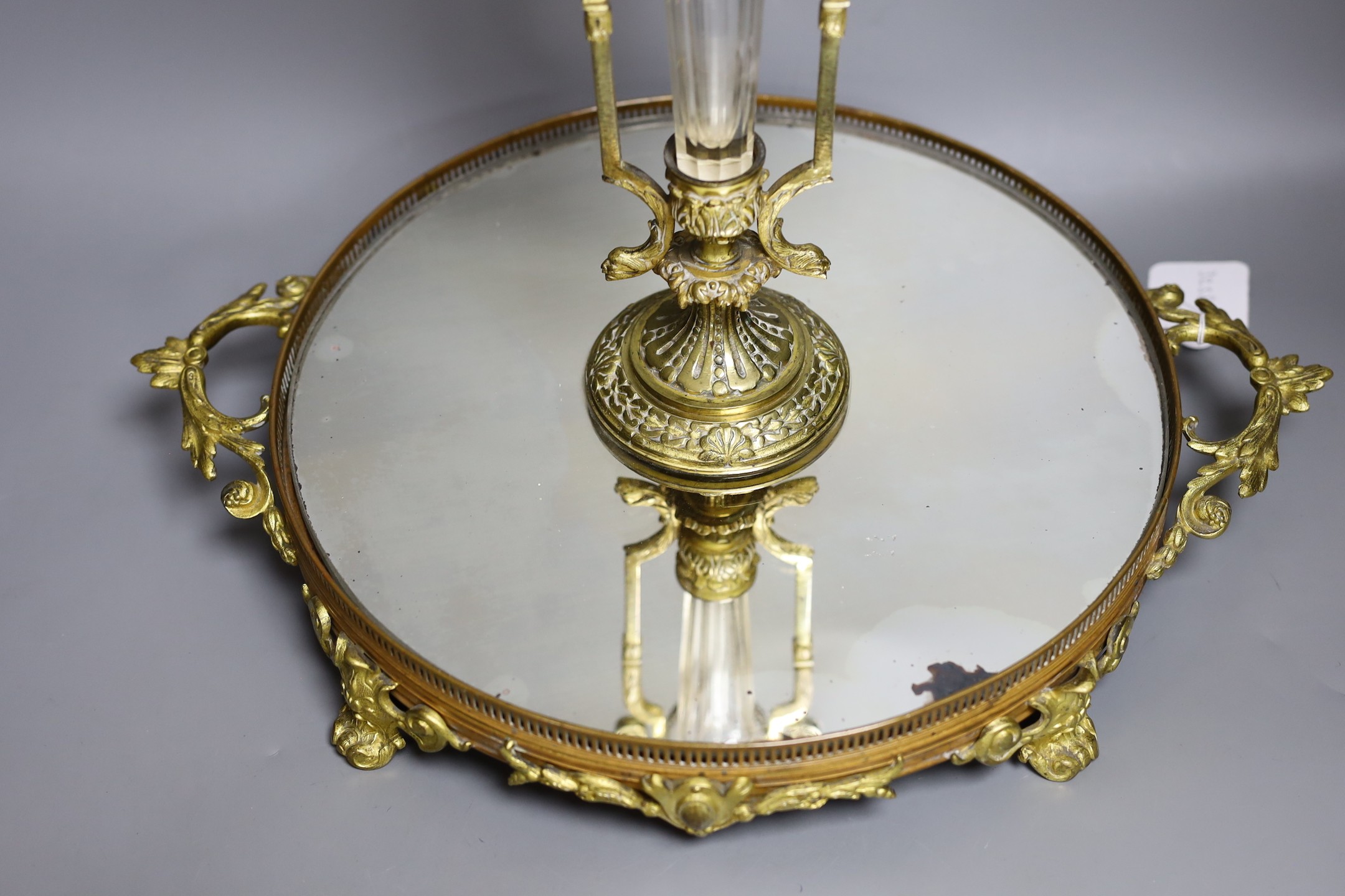 An ormolu and patinated bronze centrepiece with mirrored base and Baccarat style epergne vase, base signed Henry, 44cms high